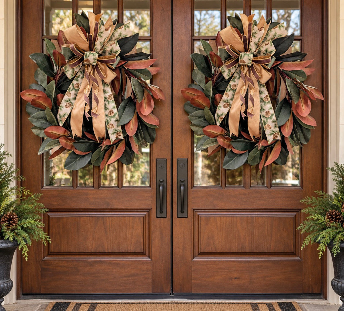 32 inch magnolia wreath with fall pinecone bow on double wooden doors
