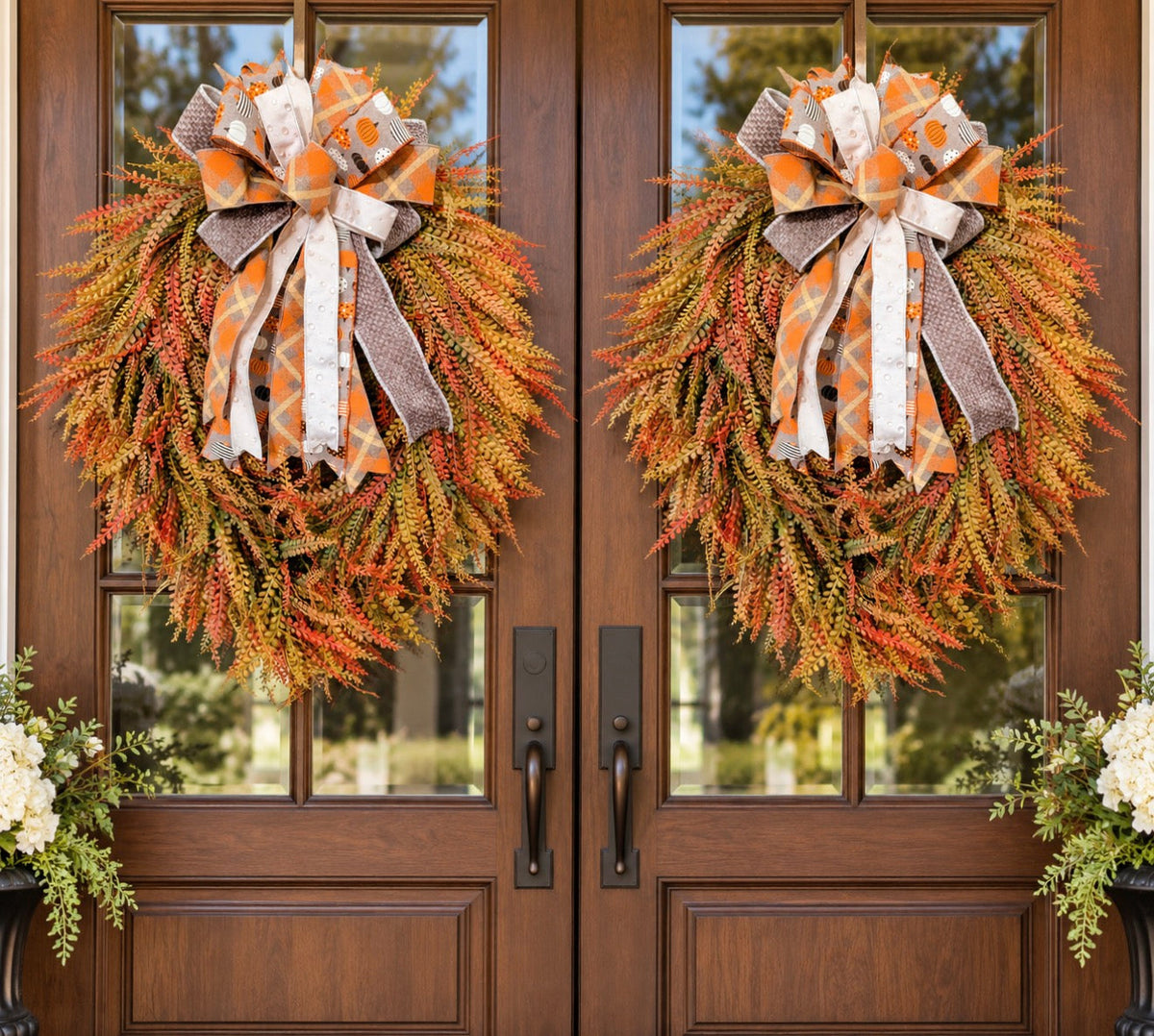 34 inch Deluxe Oval Beadgrass Wreath in orange and gold with plaid pumpkin bow on wooden double doors